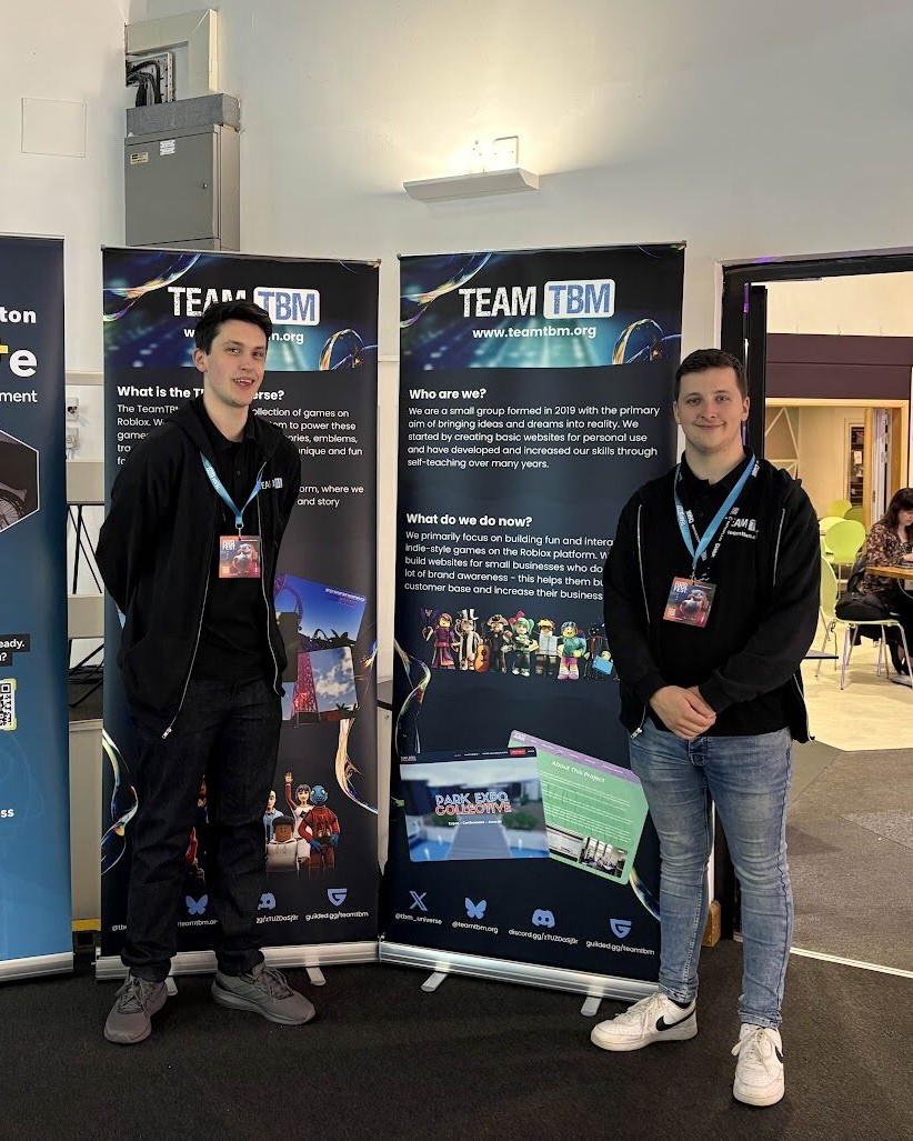 Ben McCormick standing next to the TeamTBM banner at the exhibition hall.